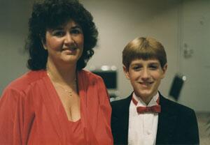 Ryan White with his mother and they are dressed up.